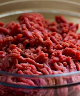 High-quality image of fresh ground beef in a glass bowl, ideal for culinary and food-related themes.