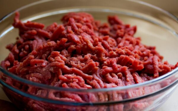 High-quality image of fresh ground beef in a glass bowl, ideal for culinary and food-related themes.