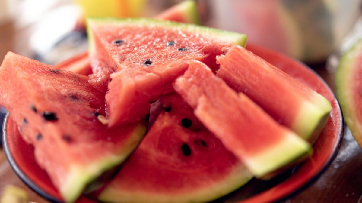 Close-up of fresh, sliced watermelons on a plate perfect for summer refreshment.