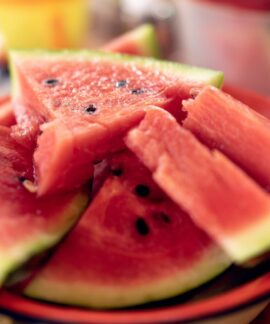 Close-up of fresh, sliced watermelons on a plate perfect for summer refreshment.