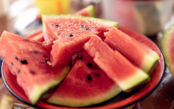 Close-up of fresh, sliced watermelons on a plate perfect for summer refreshment.