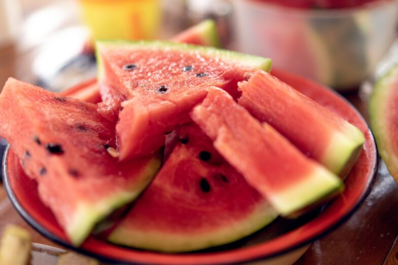 Close-up of fresh, sliced watermelons on a plate perfect for summer refreshment.