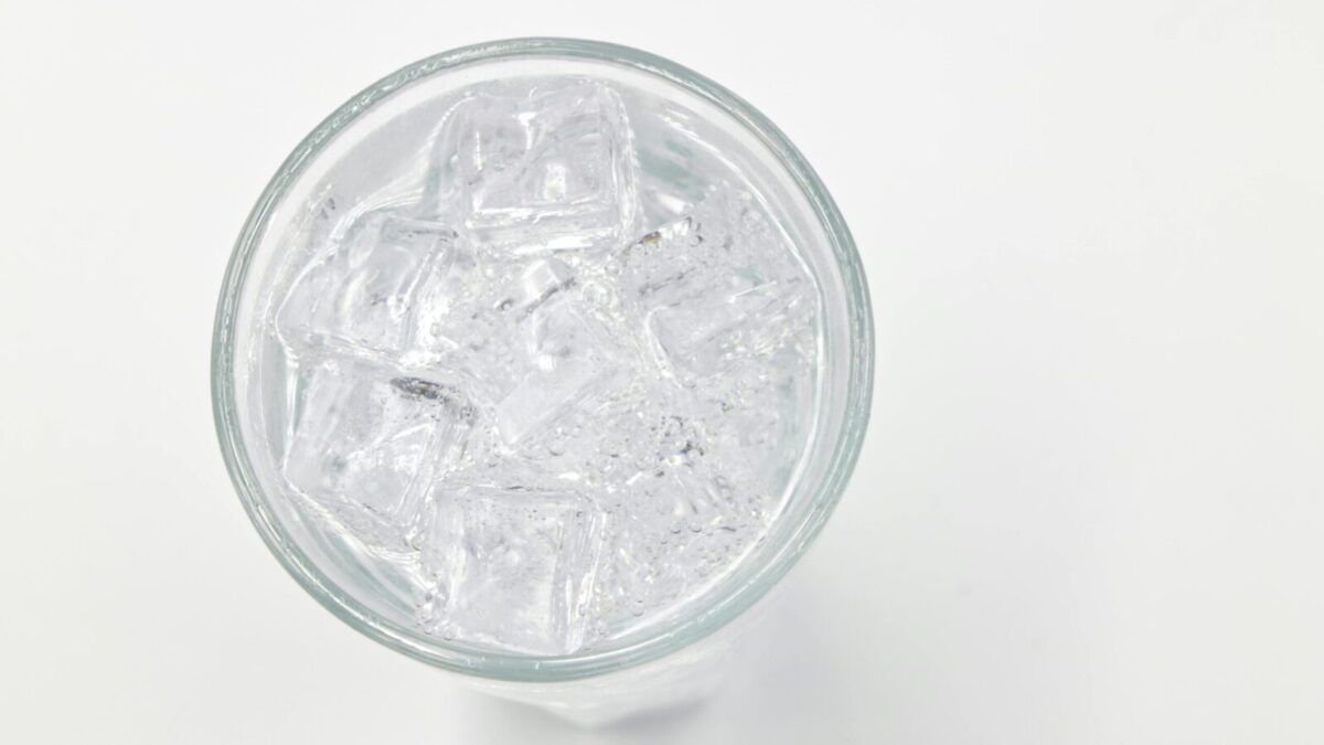 Refreshing ice cubes in a glass on a white background, perfect for drink and lifestyle themes.