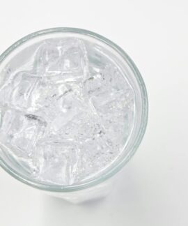 Refreshing ice cubes in a glass on a white background, perfect for drink and lifestyle themes.