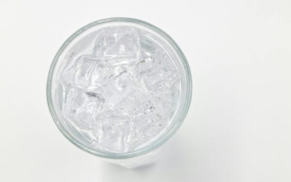 Refreshing ice cubes in a glass on a white background, perfect for drink and lifestyle themes.