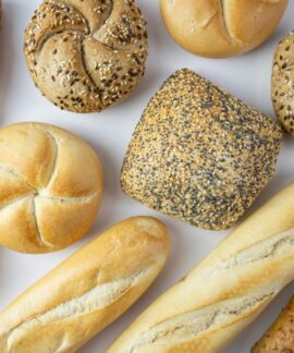 A flat lay of various freshly baked breads showcasing texture and variety.