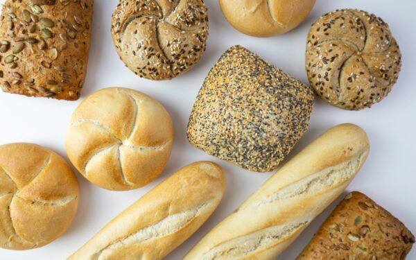 A flat lay of various freshly baked breads showcasing texture and variety.