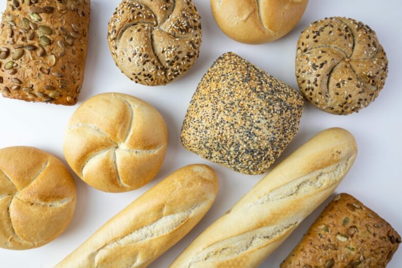 A flat lay of various freshly baked breads showcasing texture and variety.