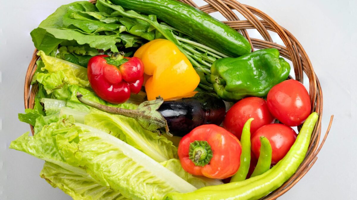 A vibrant assortment of fresh vegetables in a wicker basket. Ideal for healthy eating concepts.
