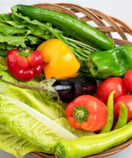 A vibrant assortment of fresh vegetables in a wicker basket. Ideal for healthy eating concepts.
