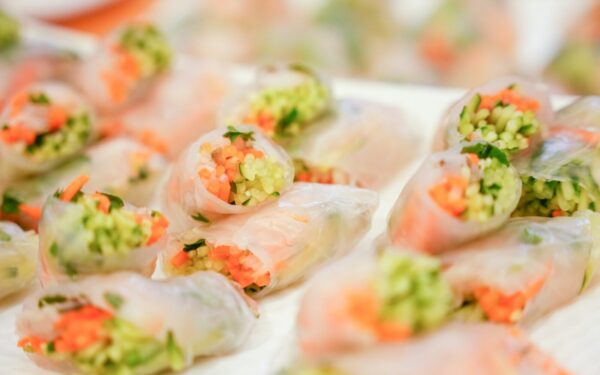 Close-up of colorful vegetable spring rolls wrapped in rice paper, perfect for a healthy snack.
