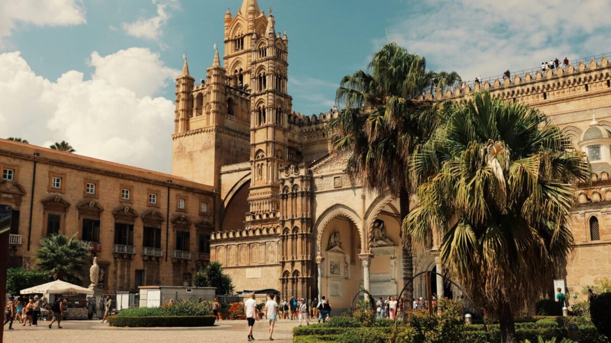 Explore the stunning architecture of Palermo Cathedral in Sicily, Italy, under a bright blue sky.
