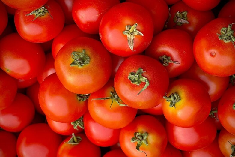Close-up of fresh red tomatoes showcasing vibrant colors and textures for food enthusiasts.