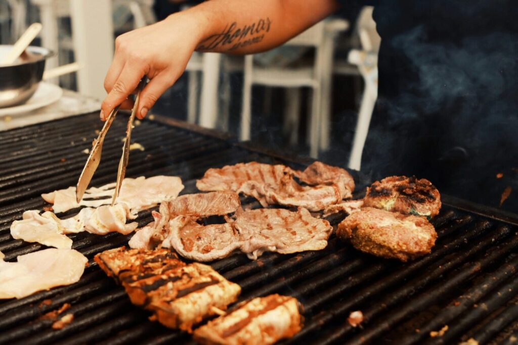Delicious grilled meats being cooked outdoors at a street market in Catania, Sicily.