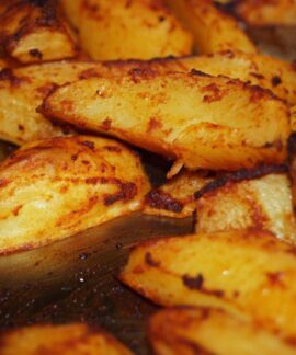 Close-up of homemade roasted potatoes with a golden crispy finish. Perfect for a delicious meal.