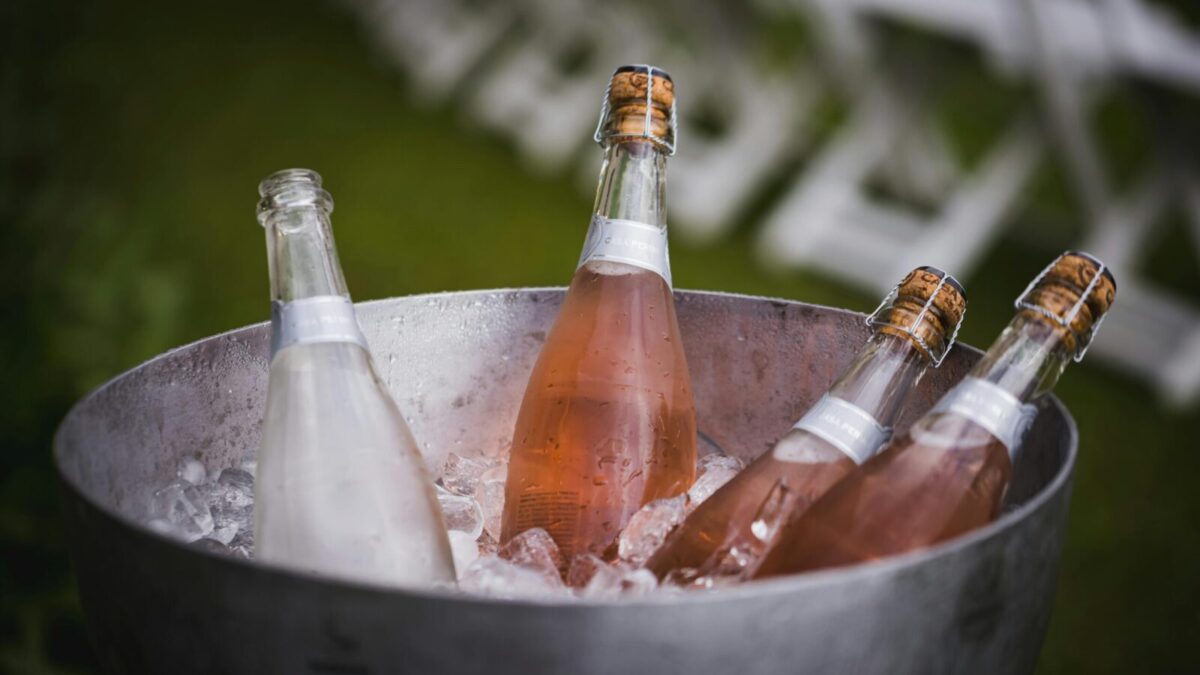 Four champagne bottles chilling in an ice bucket, perfect for celebrations or events.