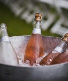 Four champagne bottles chilling in an ice bucket, perfect for celebrations or events.