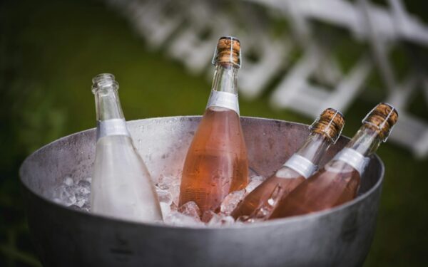 Four champagne bottles chilling in an ice bucket, perfect for celebrations or events.