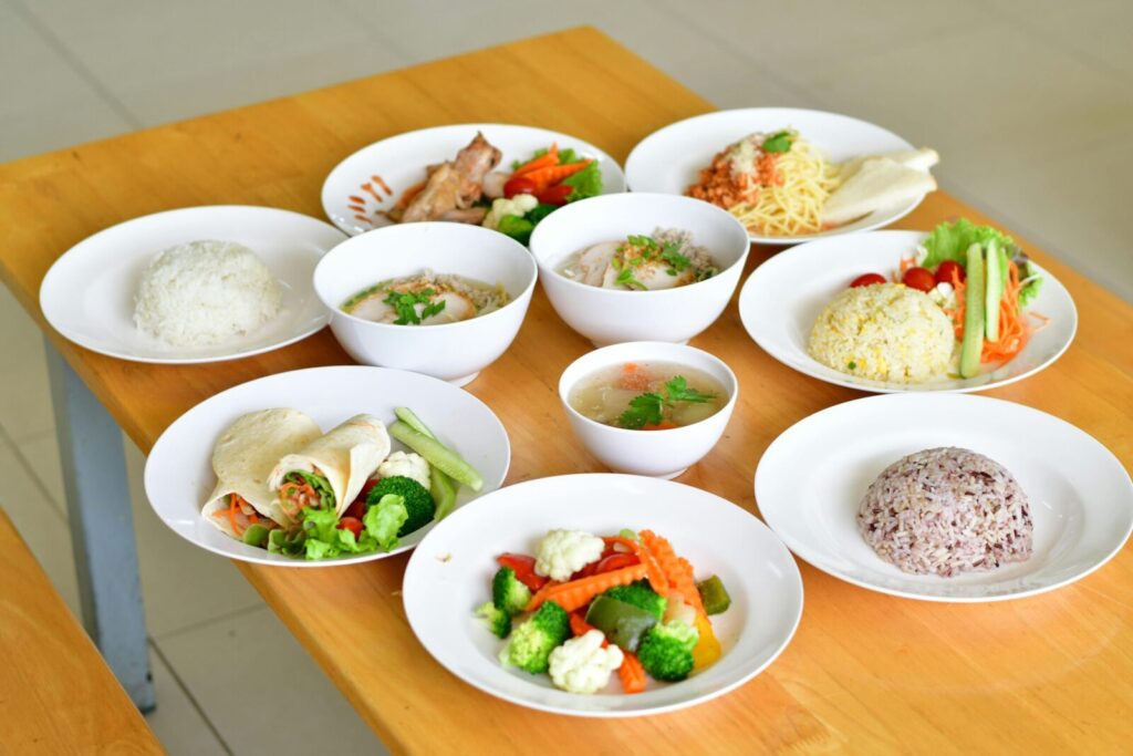 A variety of nutritious dishes displayed on a wooden table, showcasing diverse healthy meals.