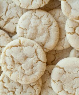 A close-up shot of homemade sugar cookies with a cracked surface, showcasing their texture.
