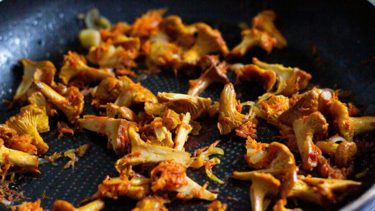 Delicious sautéed chanterelle mushrooms seasoned perfectly in a pan. Perfect for gourmet recipes.