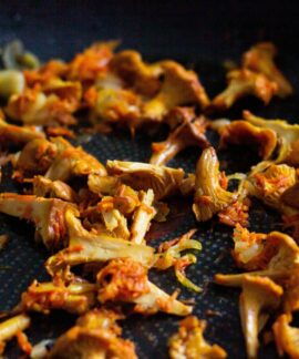Delicious sautéed chanterelle mushrooms seasoned perfectly in a pan. Perfect for gourmet recipes.