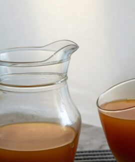 Refreshing orange juice served in a glass and jug, perfect for a healthy summer drink.