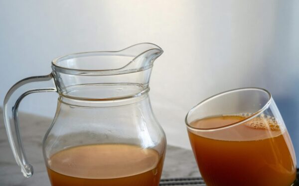 Refreshing orange juice served in a glass and jug, perfect for a healthy summer drink.