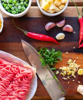 Fresh ingredients displayed on a cutting board, perfect for preparing a spicy beef stir fry.