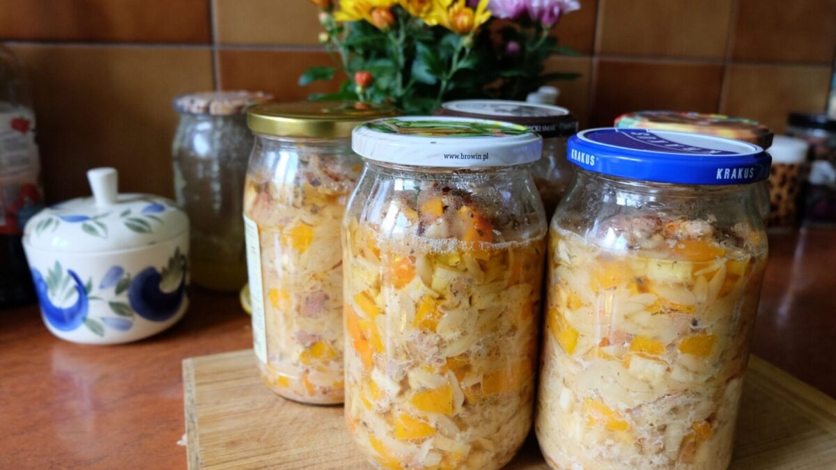 Colorful homemade pickled vegetables sealed in jars, displayed on a kitchen countertop.