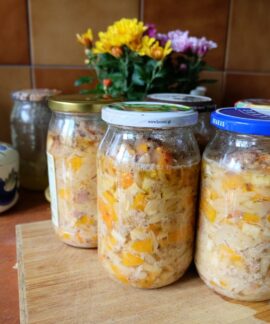 Colorful homemade pickled vegetables sealed in jars, displayed on a kitchen countertop.