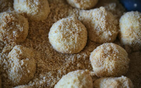 Delicious breadcrumb-coated dumplings ready for cooking, showcasing texture and flavor.