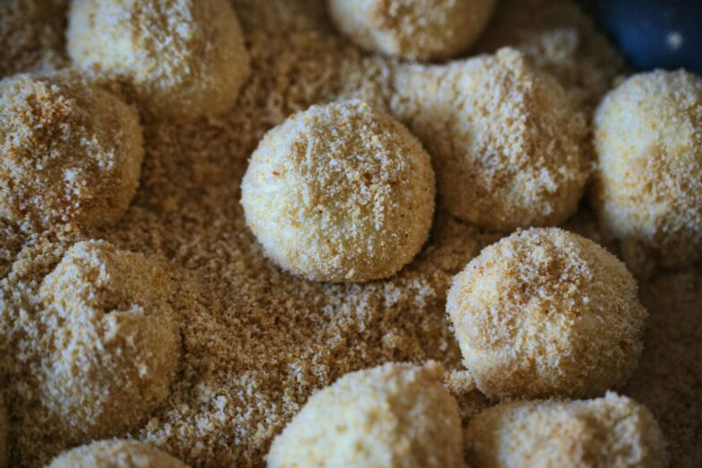 Delicious breadcrumb-coated dumplings ready for cooking, showcasing texture and flavor.