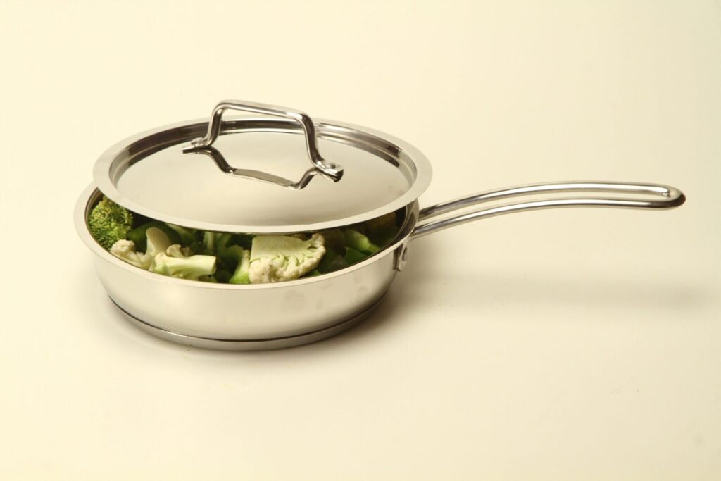 Modern stainless steel pan with vegetables, ideal for healthy cooking.