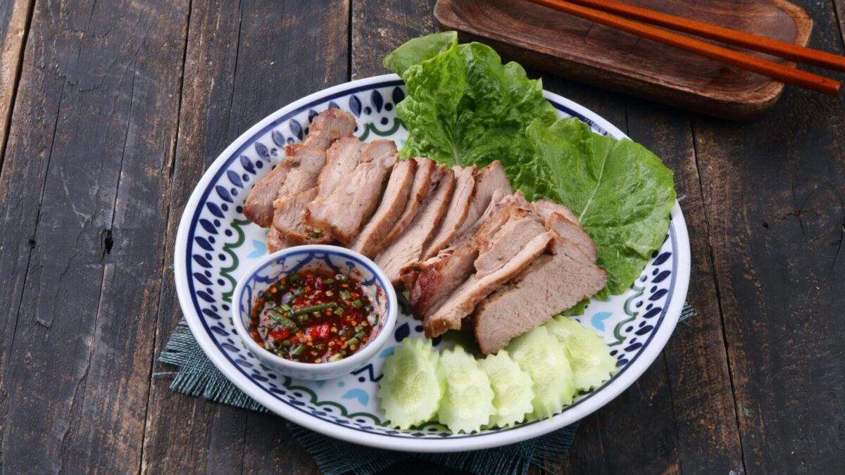 Sliced grilled pork served with fresh lettuce, cucumbers, and spicy dipping sauce.
