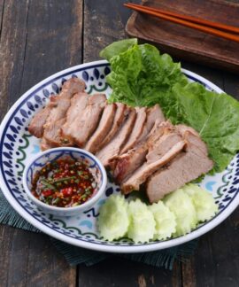Sliced grilled pork served with fresh lettuce, cucumbers, and spicy dipping sauce.