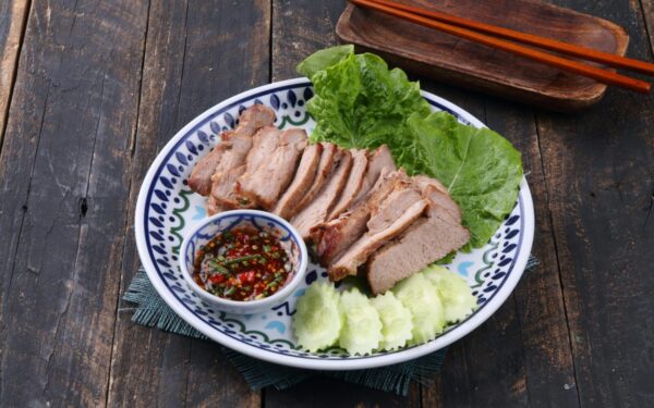 Sliced grilled pork served with fresh lettuce, cucumbers, and spicy dipping sauce.