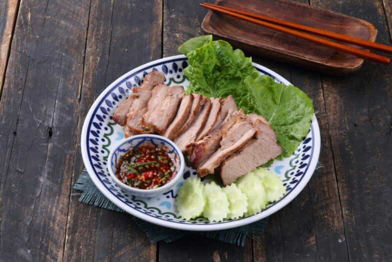 Sliced grilled pork served with fresh lettuce, cucumbers, and spicy dipping sauce.