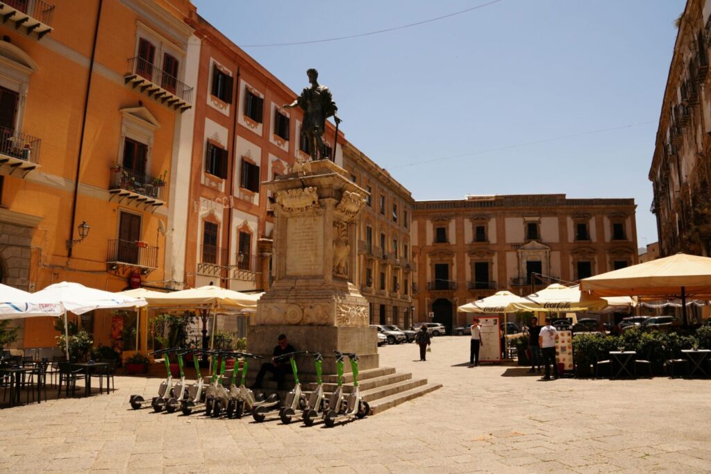 Vibrant street scene at a historic piazza in Palermo, Sicily, Italy.