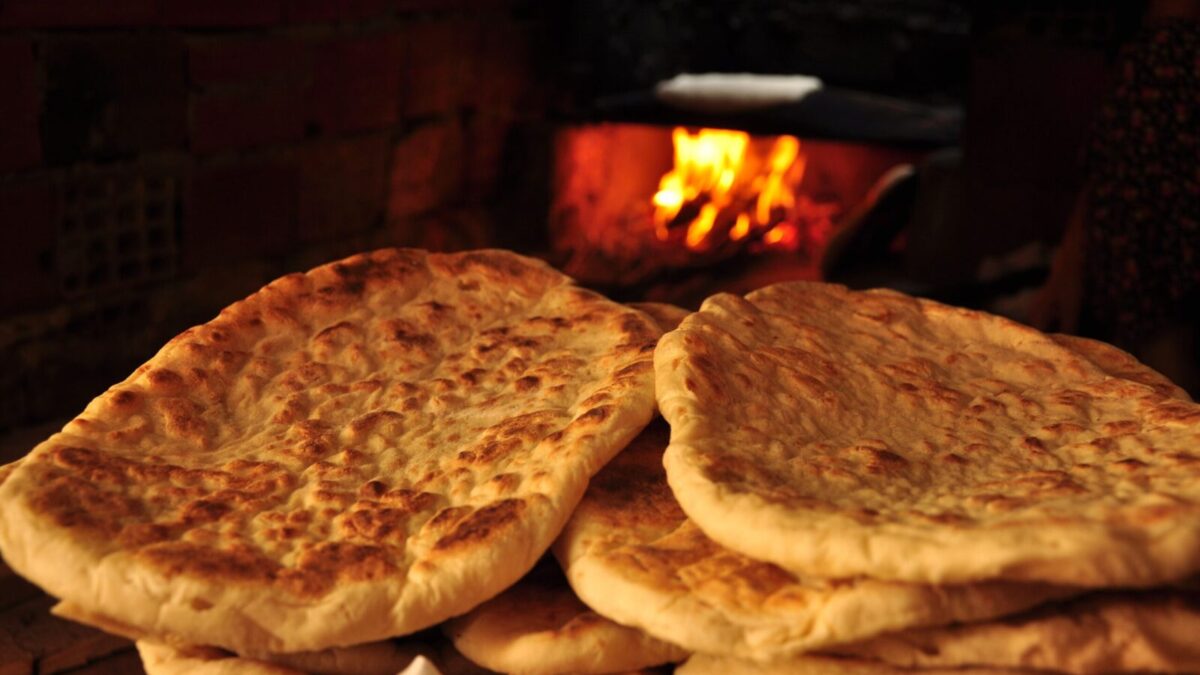 Freshly baked pita bread in a rustic Turkish oven, showcasing traditional baking methods.