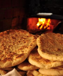 Freshly baked pita bread in a rustic Turkish oven, showcasing traditional baking methods.