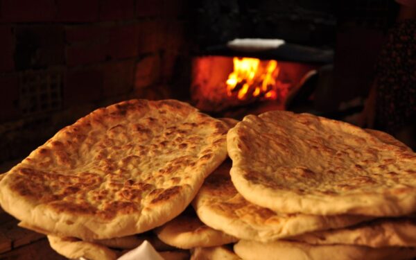 Freshly baked pita bread in a rustic Turkish oven, showcasing traditional baking methods.