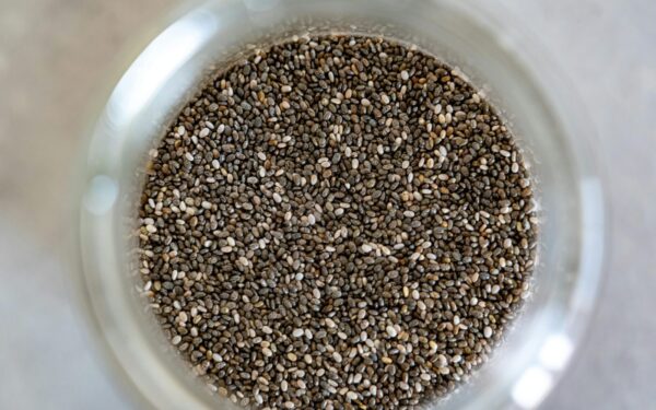 High-angle view of chia seeds in a glass jar, perfect for healthy cooking.
