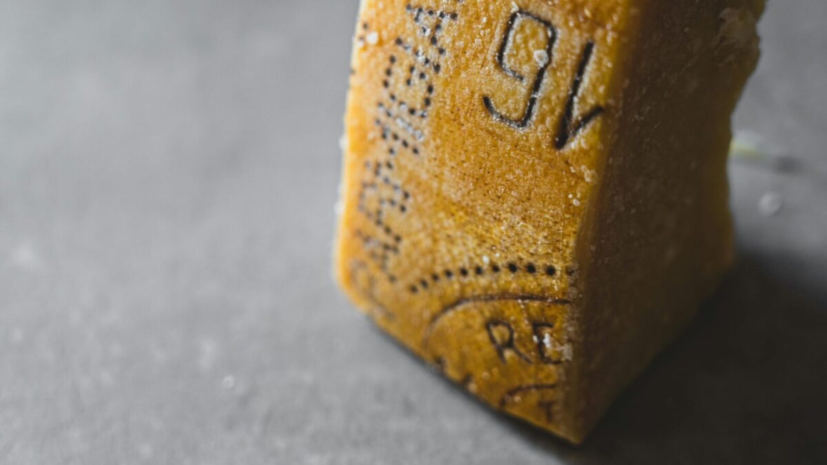 Detailed close-up of Parmesan cheese showing aged texture and salt crystals.