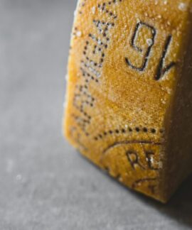 Detailed close-up of Parmesan cheese showing aged texture and salt crystals.