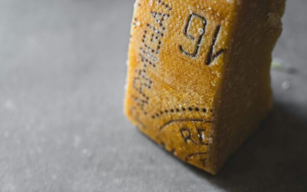 Detailed close-up of Parmesan cheese showing aged texture and salt crystals.