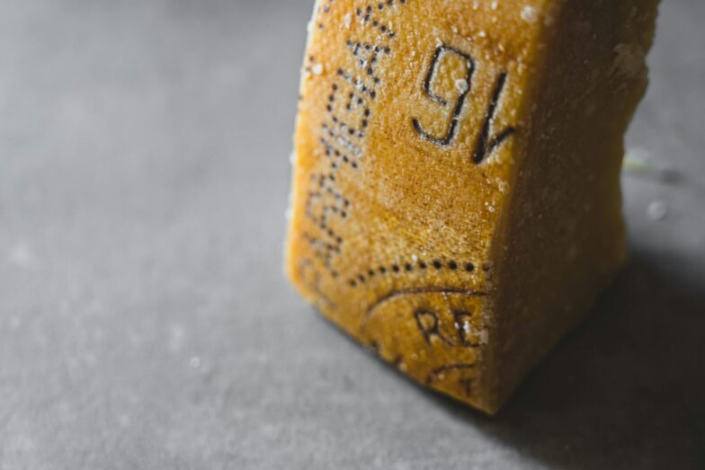 Detailed close-up of Parmesan cheese showing aged texture and salt crystals.