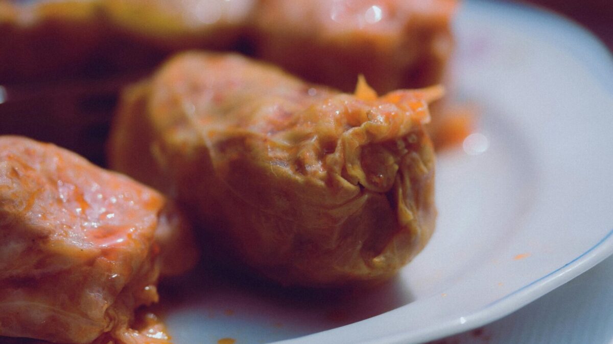 Delicious homemade stuffed cabbage rolls served on a white plate.