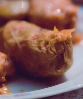 Delicious homemade stuffed cabbage rolls served on a white plate.