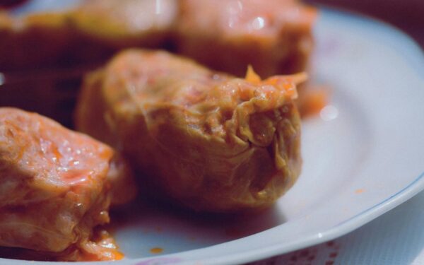 Delicious homemade stuffed cabbage rolls served on a white plate.